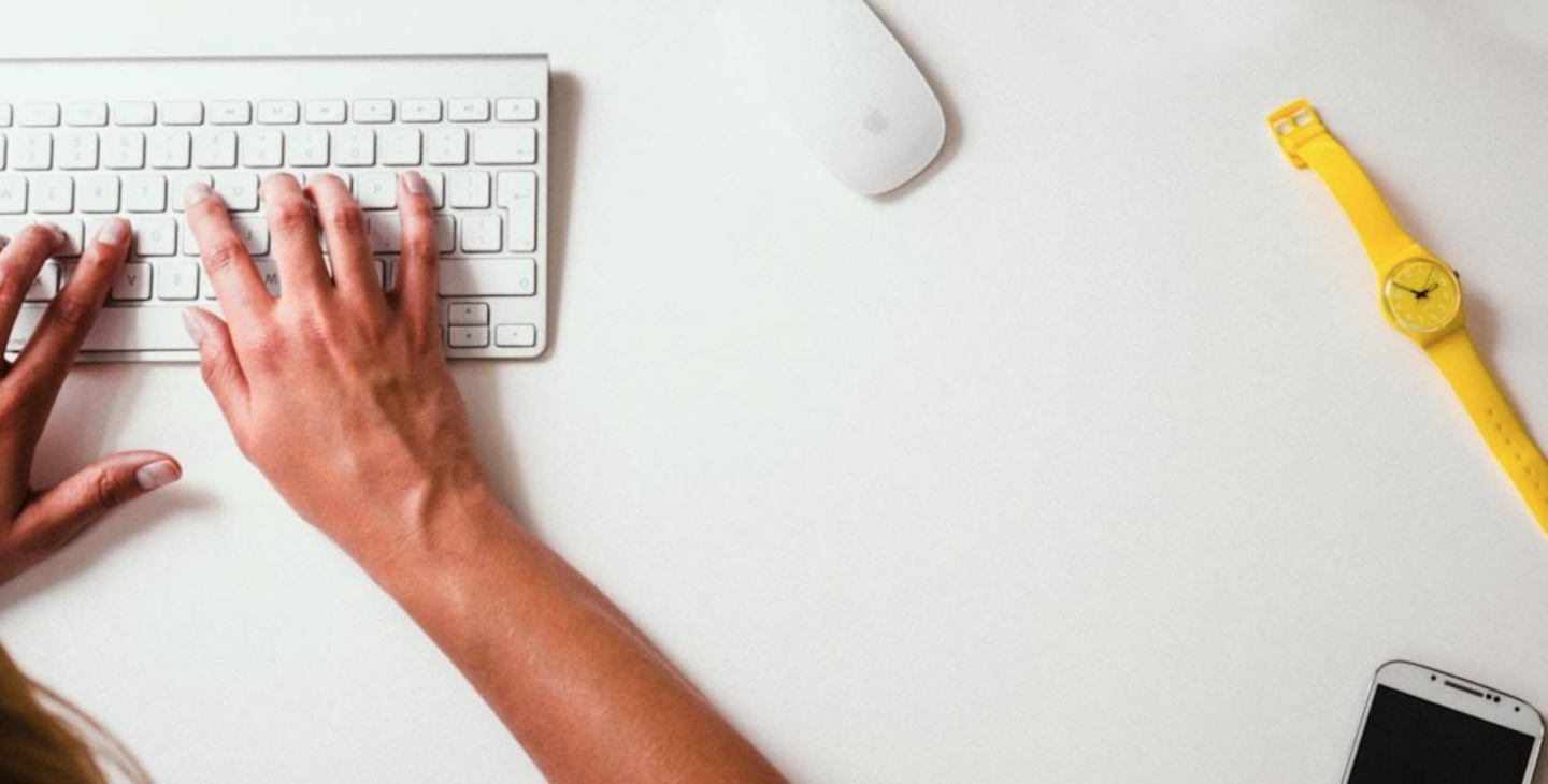 An individual using a laptop to explore omnichannel support for a cohesive customer experience.